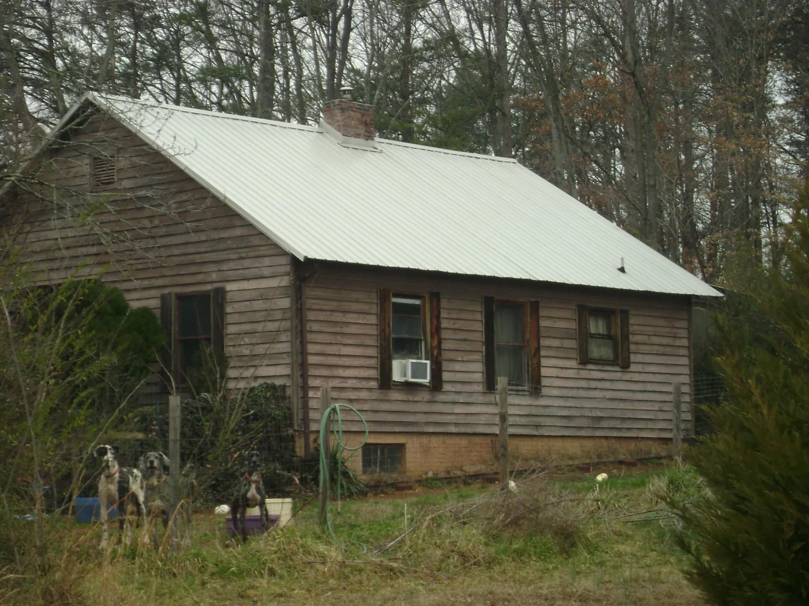 White metal roof on an old wood sided farmhouse, from a Metal Roof Installation job in Mc Kees Rocks